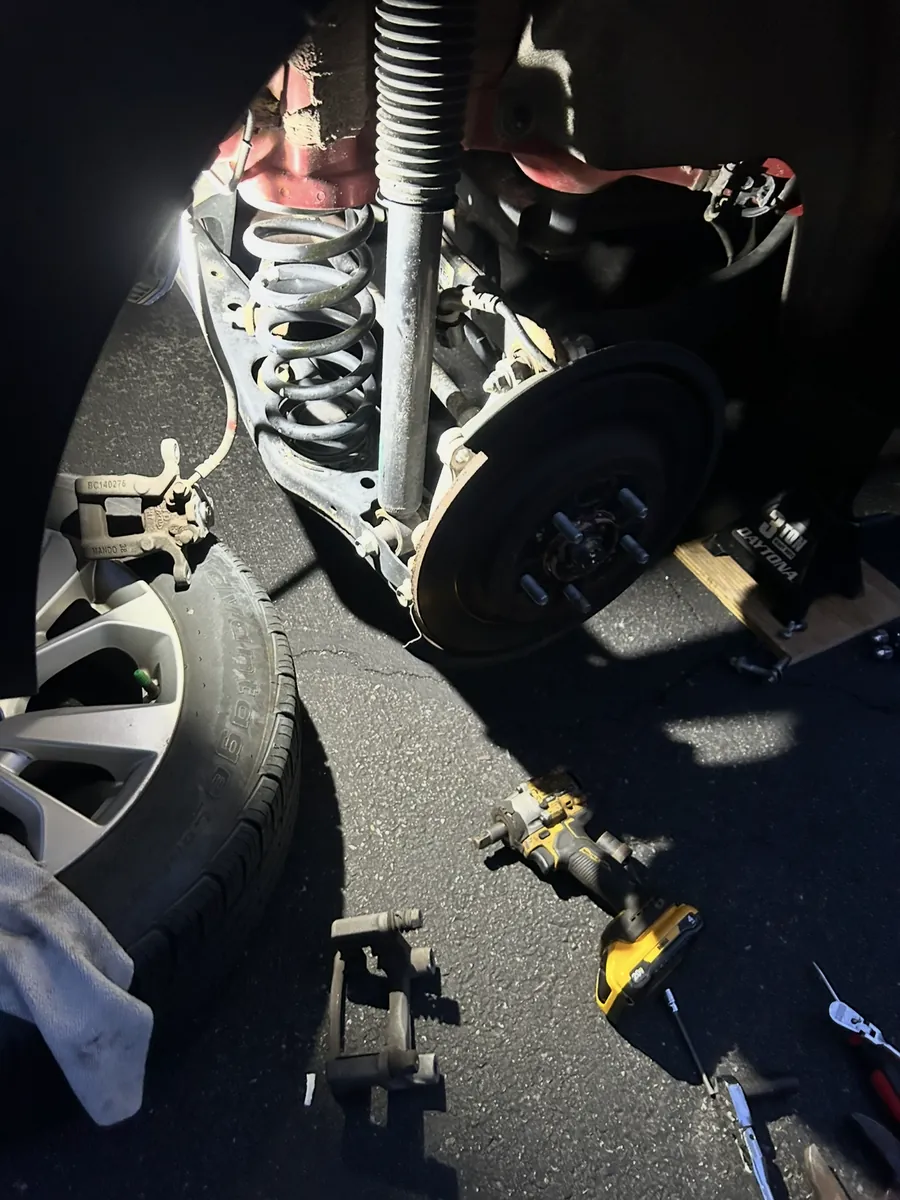 Brake and suspension work at night with the wheel removed